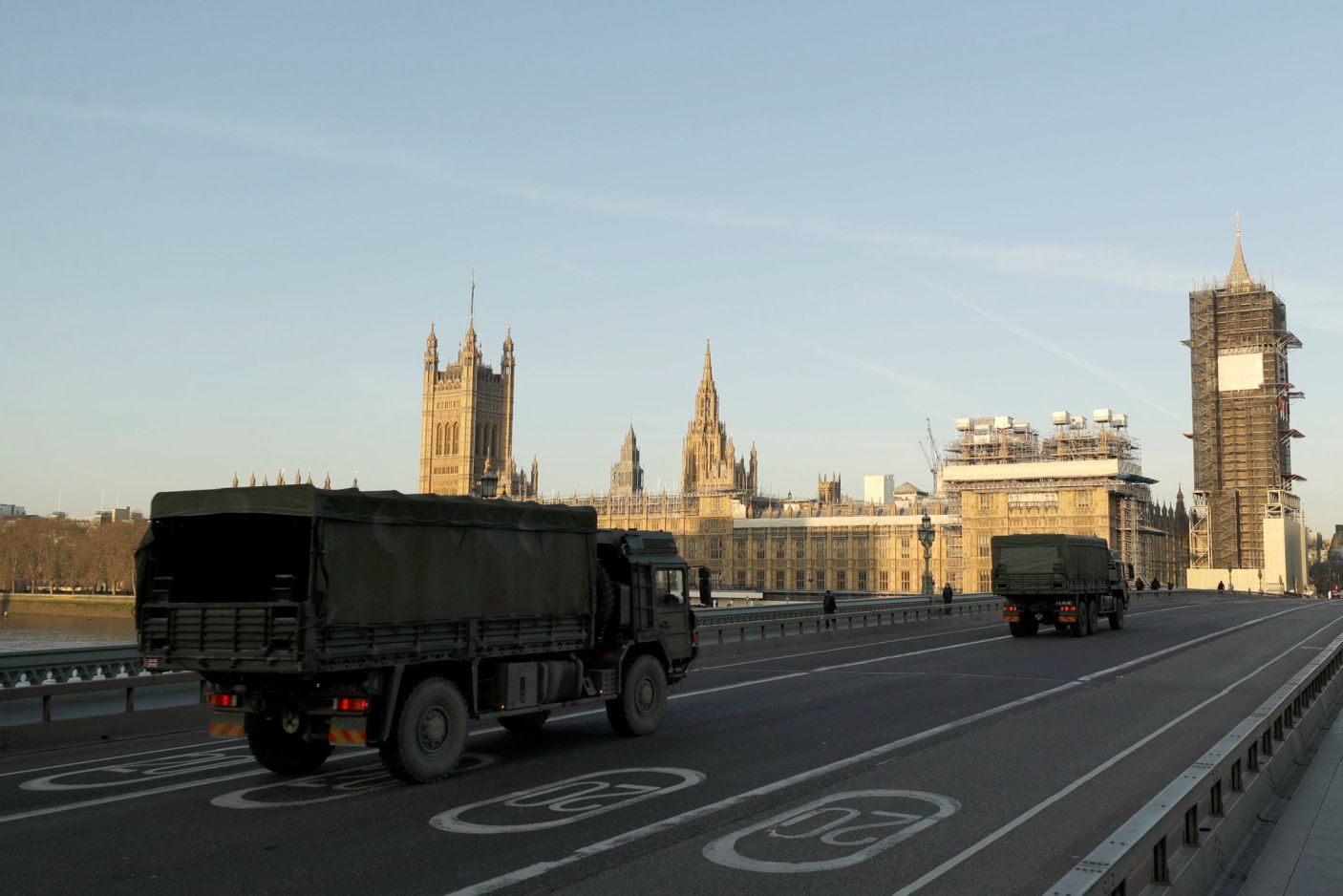 British Army trucks cross Westminster Bridge towards the Houses of Parliament in London, March 24, 2020.